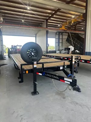 A 24ft Load Trail deckover flatbed trailer in a workshop