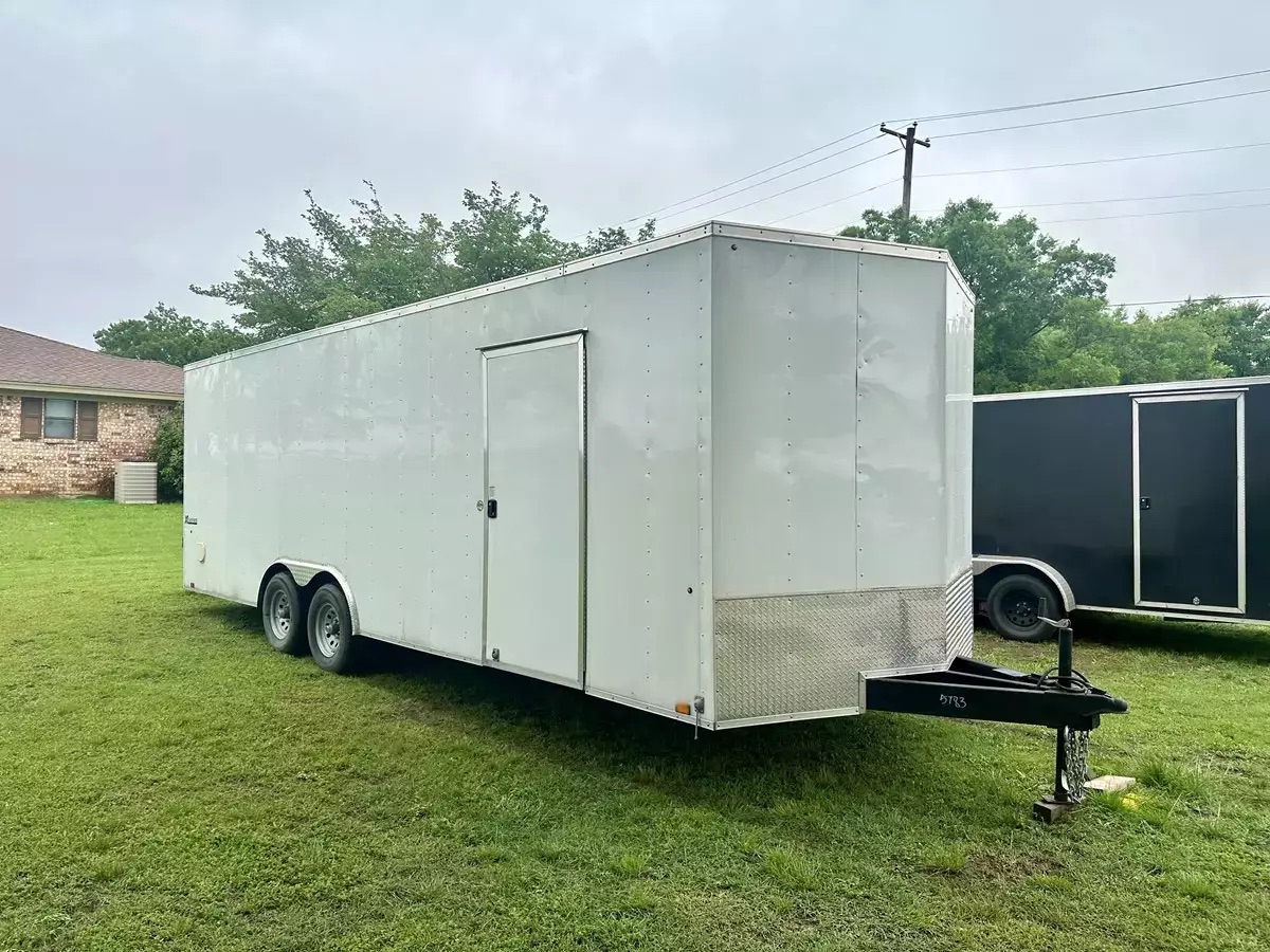 A large 24ft grey enclosed cargo trailer